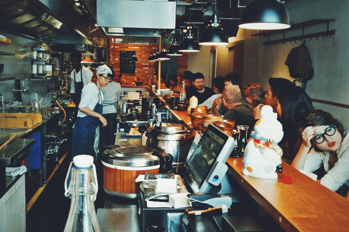 Crowded restaurant dining area during peak hours with customers being served