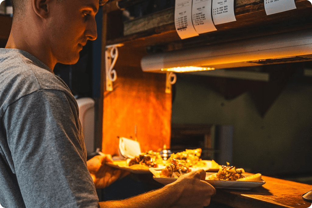 Staff at Small Bar serving food