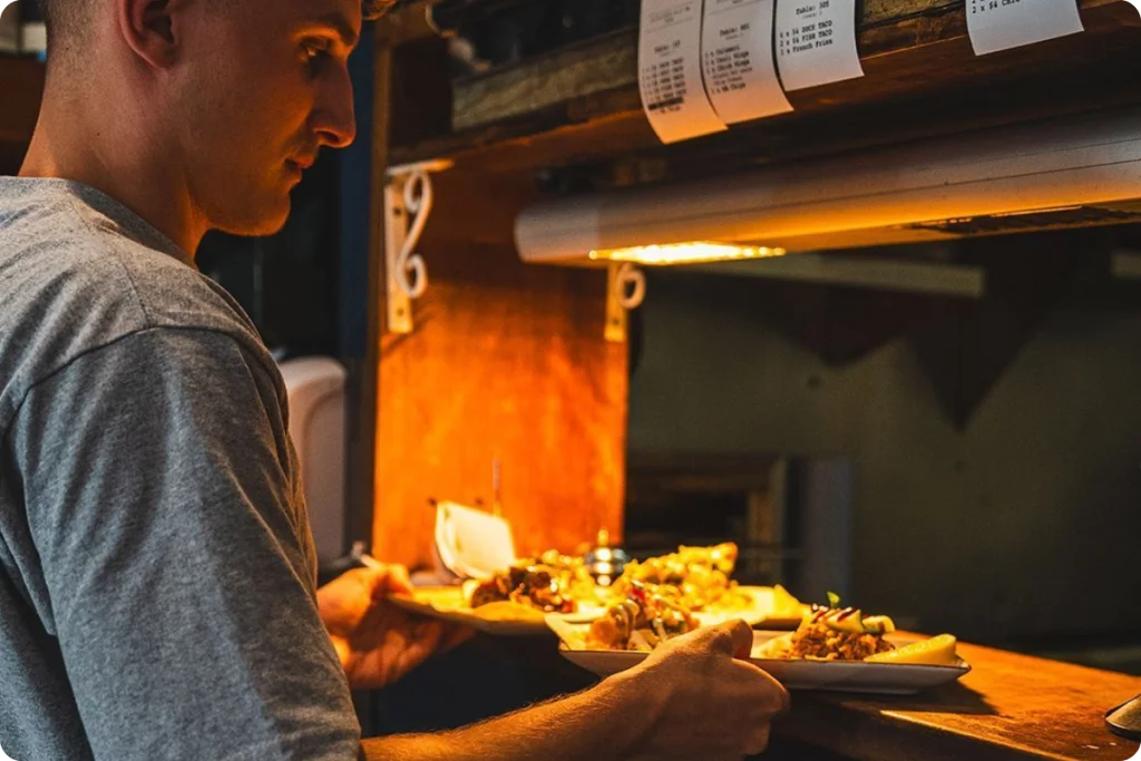Staff at Small Bar serving food