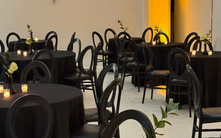 Large event space with elegant decor, dining tables and chairs