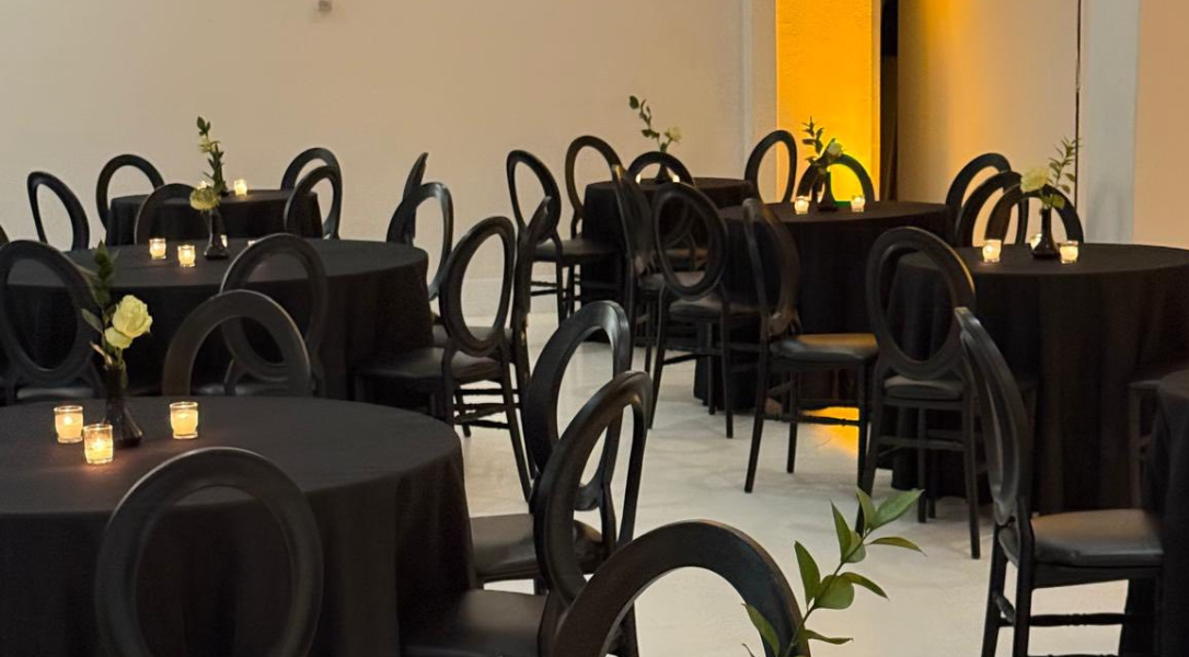 Large event space with elegant decor, dining tables and chairs