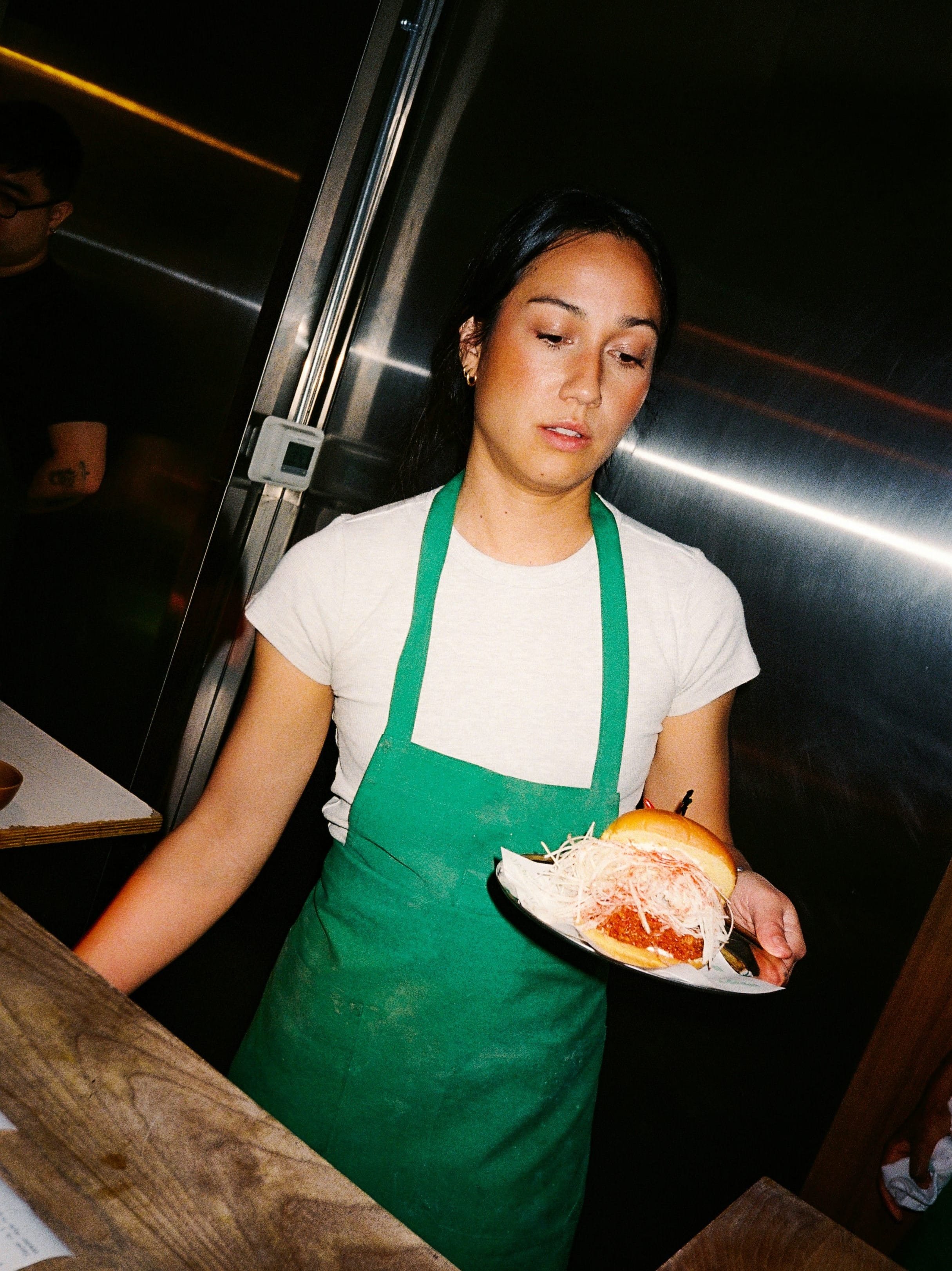Restaurant staff serving a dish from the kitchen