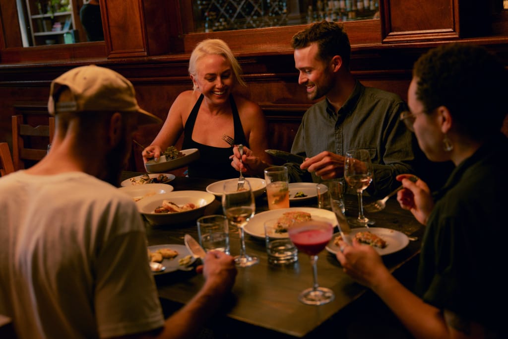 Happy customers around a restaurant table