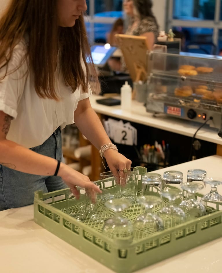 Barista clearing cups at the counter