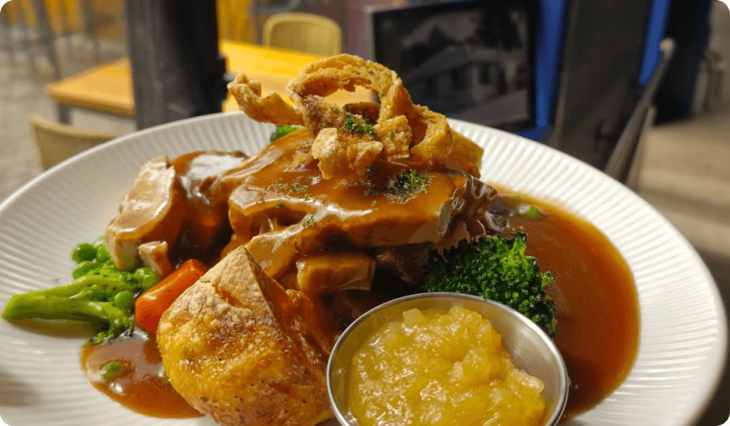 Full English breakfast with Yorkshire pudding, gravy and peas.
