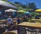 Pub goers gathering at a table with umbrellas.