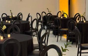 Large event space with elegant decor, dining tables and chairs